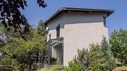 A single-family house with a large yard next to the Bells